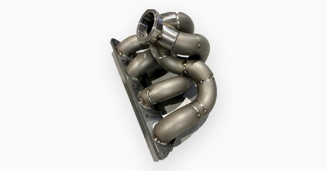 Mild steel SCH40 four cylinder turbo manifold built from steampipe elbows with a V-band turbo flange
